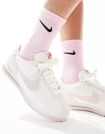 Nike Cortez Leather trainers in off-white and pink offers at S$ 89.99 in asos